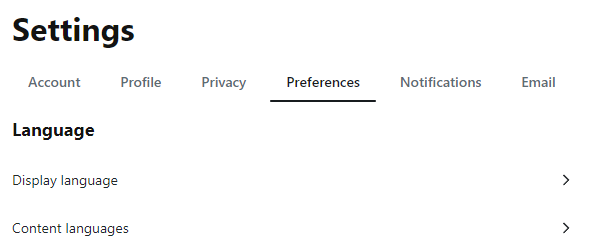 Uma página escrita "Settings," com as abas: Account, Profile, Privacy, Preferences (selecionado), Notifications, Email. Seção "Language." Opções: Display language. Content languages.